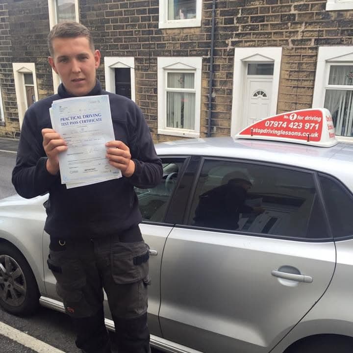 Newly passed learner holding their practical test pass certificate beside the One Stop School of Motoring car